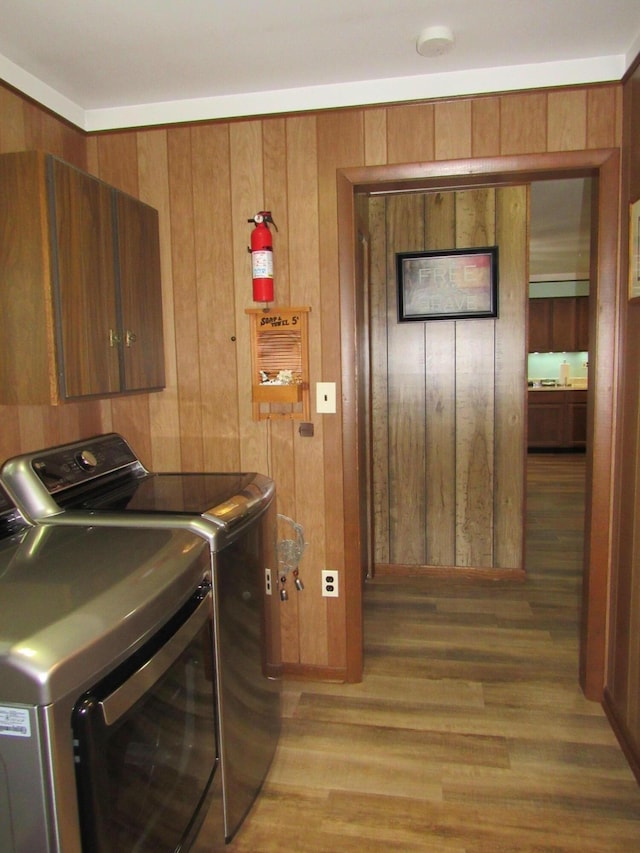 110 Chippewa Trl, Prudenville, MI 48651 - laundry room featuring washer and clothes dryer, light wood-style floors, and wooden walls