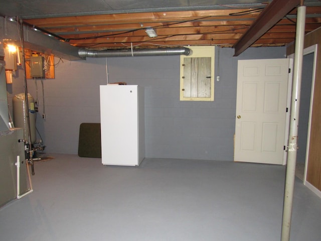 110 Chippewa Trl, Prudenville, MI 48651 - unfinished basement with electric panel, concrete block wall, and a water pressure tank