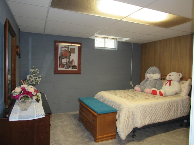 110 Chippewa Trl, Prudenville, MI 48651 - bedroom featuring a drop ceiling, light carpet, concrete block wall, and wooden walls