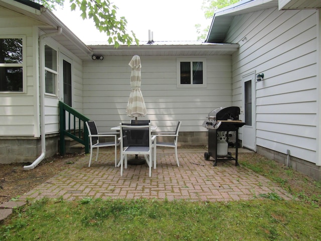 110 Chippewa Trl, Prudenville, MI 48651 - view of patio featuring a grill and entry steps
