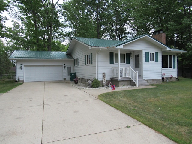 110 Chippewa Trl, Prudenville, MI 48651 - single story home featuring concrete driveway, a front yard, an attached garage, a metal roof, and a chimney