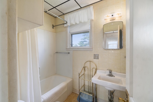 757 N Main St, Cheboygan, MI 49721 - bathroom with tile walls, shower / bath combination with curtain, and a drop ceiling
