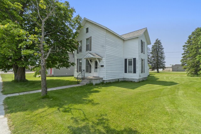 757 N Main St, Cheboygan, MI 49721 - view of front facade with a front lawn and roof with shingles