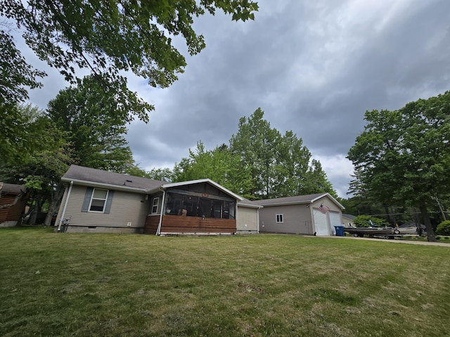 6709C E Houghton Lake Dr, Houghton Lake, MI 48629 - back of property featuring a sunroom, a lawn, and crawl space