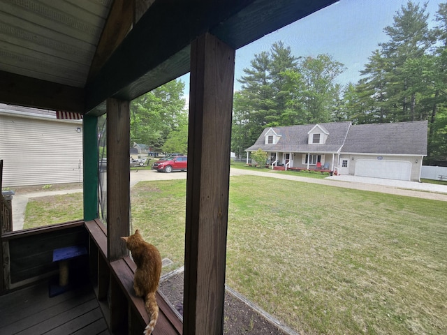 6709C E Houghton Lake Dr, Houghton Lake, MI 48629 - view of grassy yard featuring covered porch and a garage