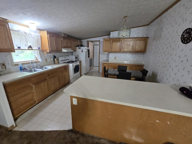 6709C E Houghton Lake Dr, Houghton Lake, MI 48629 - kitchen with white appliances, under cabinet range hood, lofted ceiling, crown molding, and brown cabinets