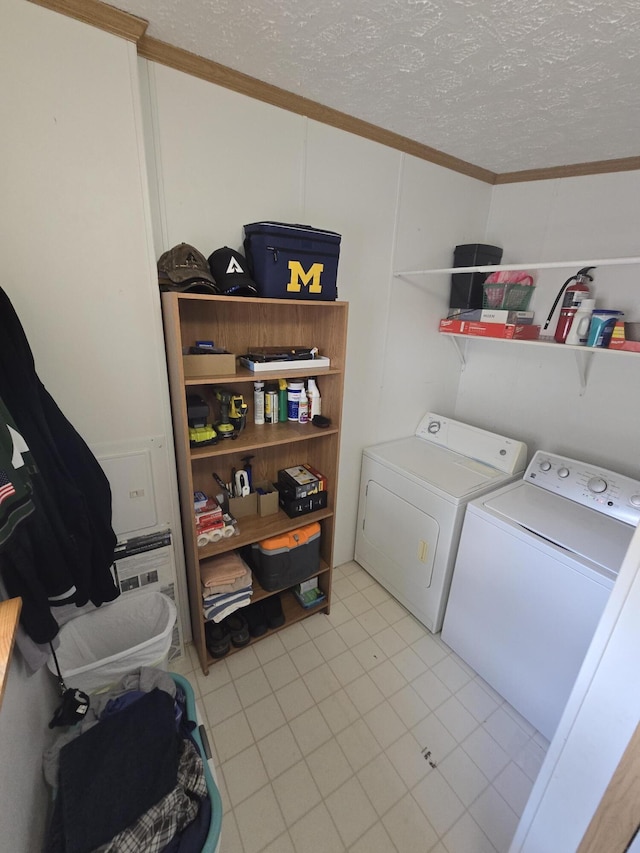 6709C E Houghton Lake Dr, Houghton Lake, MI 48629 - washroom featuring washer and clothes dryer, ornamental molding, and a textured ceiling