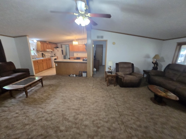 6709C E Houghton Lake Dr, Houghton Lake, MI 48629 - carpeted living room with lofted ceiling, a ceiling fan, and ornamental molding