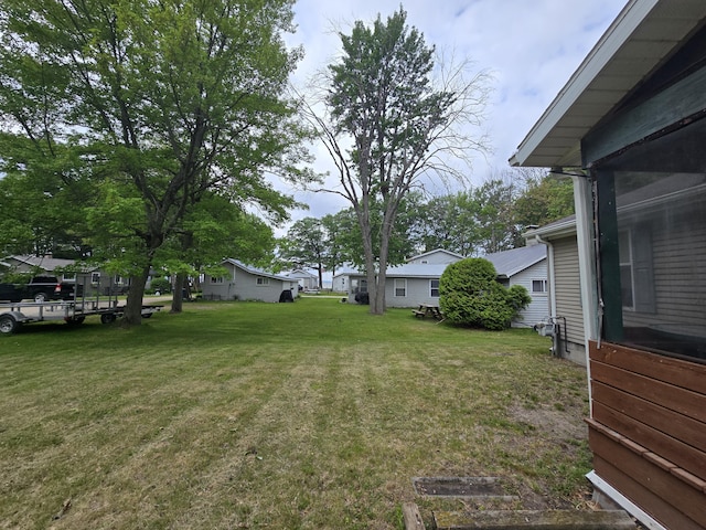 6709C E Houghton Lake Dr, Houghton Lake, MI 48629 - view of grassy yard with a residential view