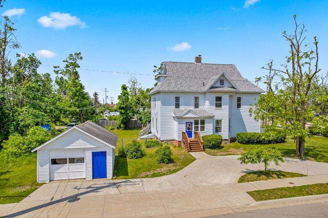 220 E Main St, Gaylord, MI 49735 - traditional-style home with an outdoor structure, a detached garage, a chimney, driveway, and a shingled roof