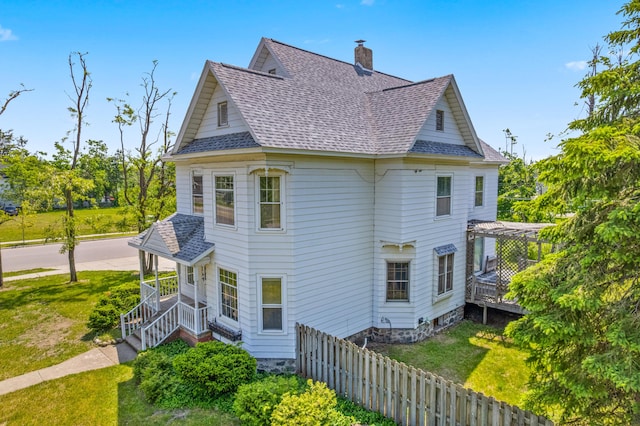 220 E Main St, Gaylord, MI 49735 - view of side of home with roof with shingles and a chimney