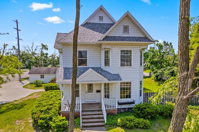 220 E Main St, Gaylord, MI 49735 - view of front facade with roof with shingles and a porch