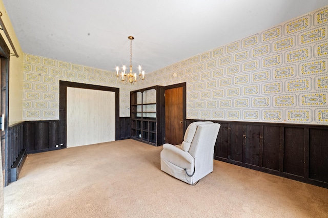 220 E Main St, Gaylord, MI 49735 - unfurnished room with wallpapered walls, wainscoting, carpet floors, and a chandelier
