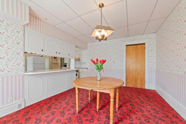 220 E Main St, Gaylord, MI 49735 - dining area featuring wallpapered walls, a wainscoted wall, and a chandelier