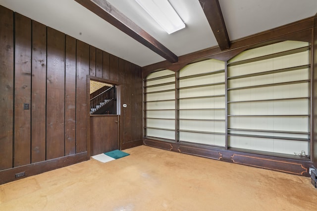 220 E Main St, Gaylord, MI 49735 - carpeted empty room featuring beamed ceiling and wooden walls