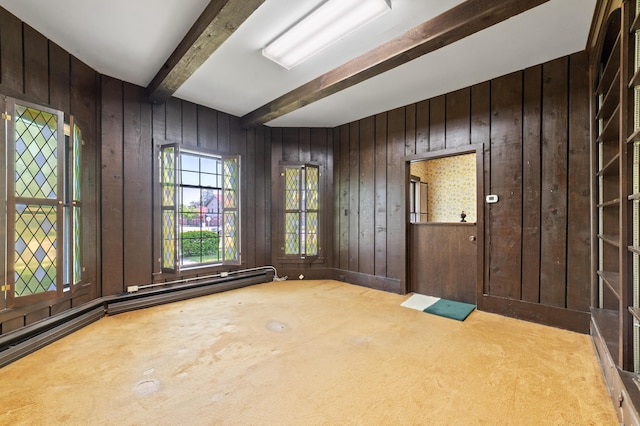 220 E Main St, Gaylord, MI 49735 - carpeted foyer with beam ceiling, wooden walls, and baseboard heating