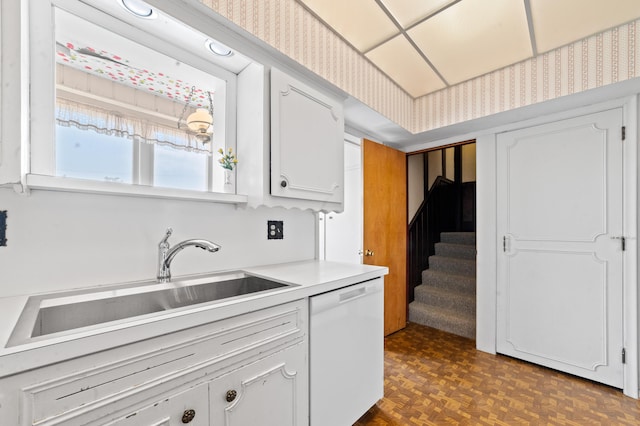 220 E Main St, Gaylord, MI 49735 - kitchen featuring white dishwasher, light countertops, and white cabinets