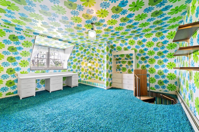 220 E Main St, Gaylord, MI 49735 - unfurnished bedroom with wallpapered walls, carpet, and a baseboard radiator