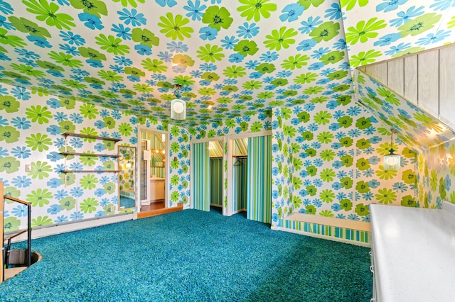 220 E Main St, Gaylord, MI 49735 - carpeted spare room with wallpapered walls and baseboard heating