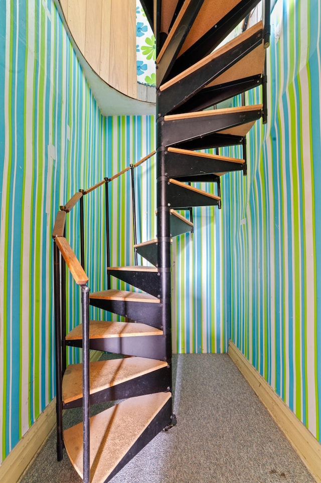 220 E Main St, Gaylord, MI 49735 - staircase with wallpapered walls and carpet floors