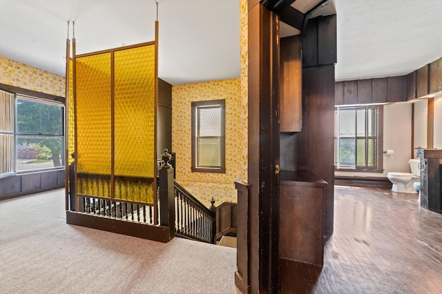 220 E Main St, Gaylord, MI 49735 - unfurnished bedroom with wallpapered walls and wood finished floors