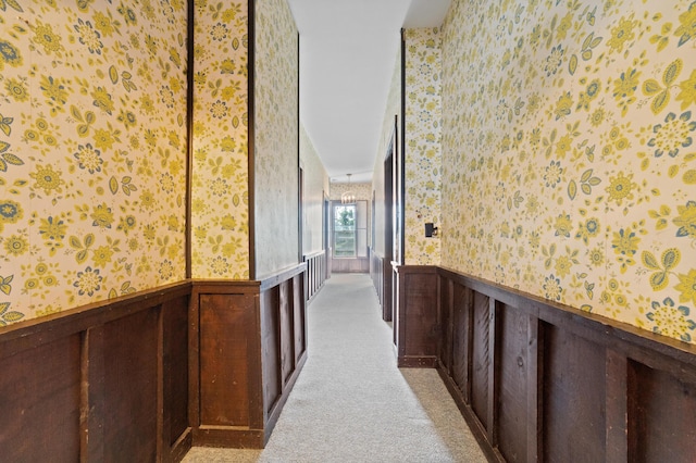220 E Main St, Gaylord, MI 49735 - hall featuring wallpapered walls, a wainscoted wall, and light colored carpet