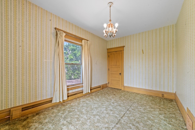 220 E Main St, Gaylord, MI 49735 - spare room featuring a chandelier and carpet flooring