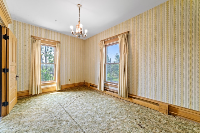 220 E Main St, Gaylord, MI 49735 - empty room with carpet flooring, healthy amount of natural light, and a chandelier