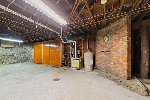 220 E Main St, Gaylord, MI 49735 - unfinished below grade area featuring a water pressure tank and a heating unit