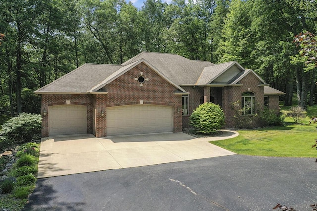 142 Frisco Dr, Houghton Lake, MI 48629 - view of front facade with driveway, an attached garage, brick siding, a front lawn, and roof with shingles