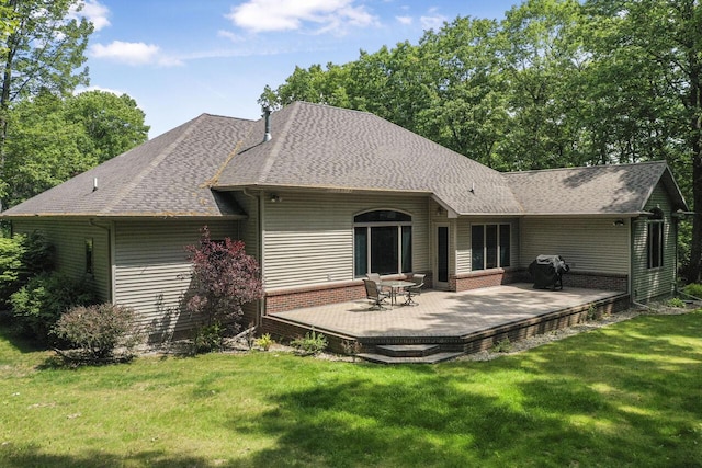 142 Frisco Dr, Houghton Lake, MI 48629 - rear view of house with a yard, roof with shingles, and a wooden deck