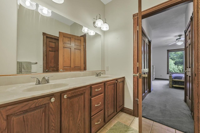 142 Frisco Dr, Houghton Lake, MI 48629 - bathroom with double vanity, ensuite bath, tile patterned floors, ceiling fan, and french doors