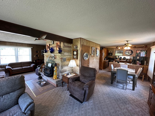 2585 M-33, Comins, MI 48619 - living room with a ceiling fan, a textured ceiling, carpet flooring, and wood walls