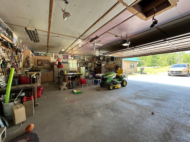 2585 M-33, Comins, MI 48619 - garage featuring a garage door opener and a workshop area