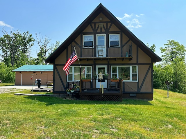 2585 M-33, Comins, MI 48619 - view of front facade featuring a balcony, a front lawn, driveway, a deck, and stucco siding
