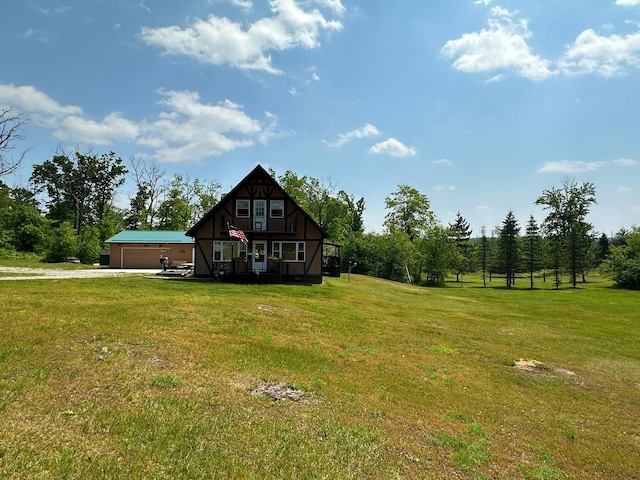 2585 M-33, Comins, MI 48619 - view of side of home featuring a lawn, an attached garage, driveway, and an outbuilding