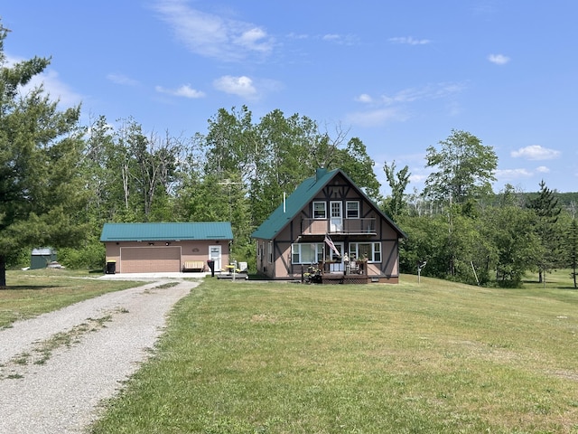 2585 M-33, Comins, MI 48619 - view of front facade featuring a garage, a front lawn, an outbuilding, and driveway