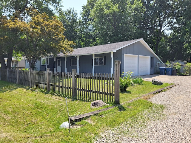 1251 Kingston Ave, Flint, MI 48507 - ranch-style home with a fenced front yard, a detached garage, and covered porch