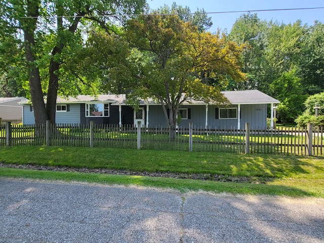 1251 Kingston Ave, Flint, MI 48507 - ranch-style home with a front lawn, board and batten siding, and covered porch