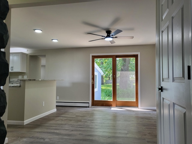 1251 Kingston Ave, Flint, MI 48507 - unfurnished living room featuring baseboard heating, ceiling fan, dark wood-style flooring, and recessed lighting