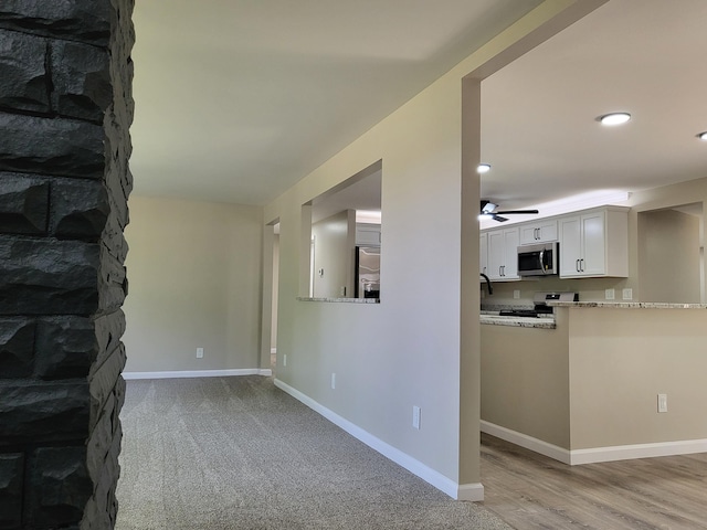 1251 Kingston Ave, Flint, MI 48507 - unfurnished living room with a ceiling fan, recessed lighting, and light wood-style floors