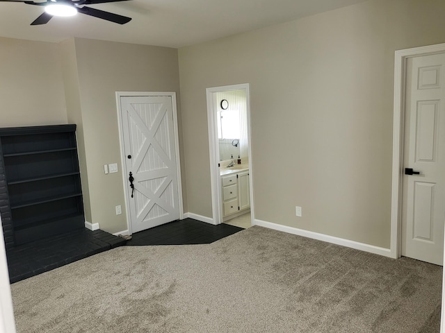 1251 Kingston Ave, Flint, MI 48507 - unfurnished bedroom with dark carpet, ensuite bathroom, and a ceiling fan