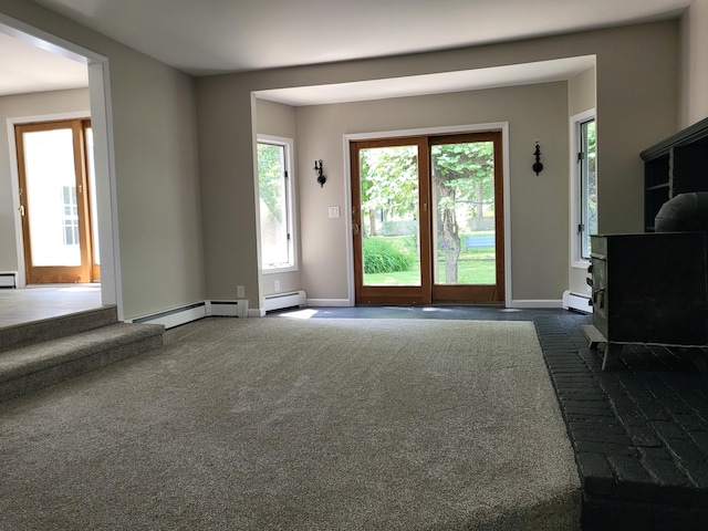 1251 Kingston Ave, Flint, MI 48507 - unfurnished living room featuring dark carpet and a baseboard heating unit