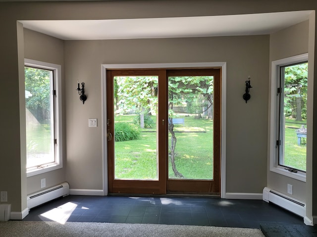 1251 Kingston Ave, Flint, MI 48507 - entryway with a baseboard heating unit, healthy amount of natural light, and dark tile patterned floors