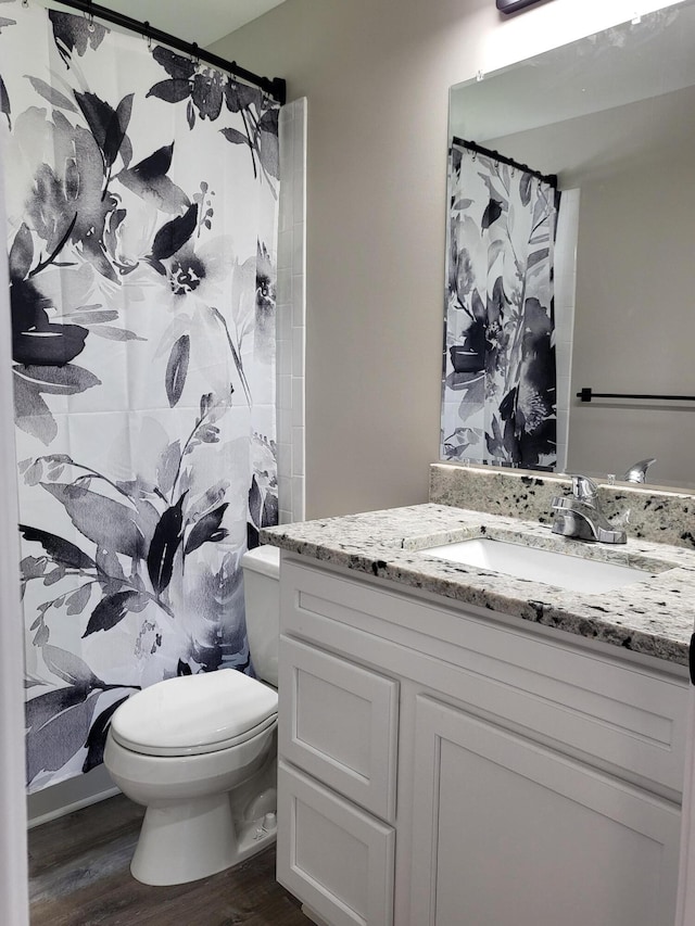 1251 Kingston Ave, Flint, MI 48507 - bathroom with wood finished floors, vanity, and a shower with curtain