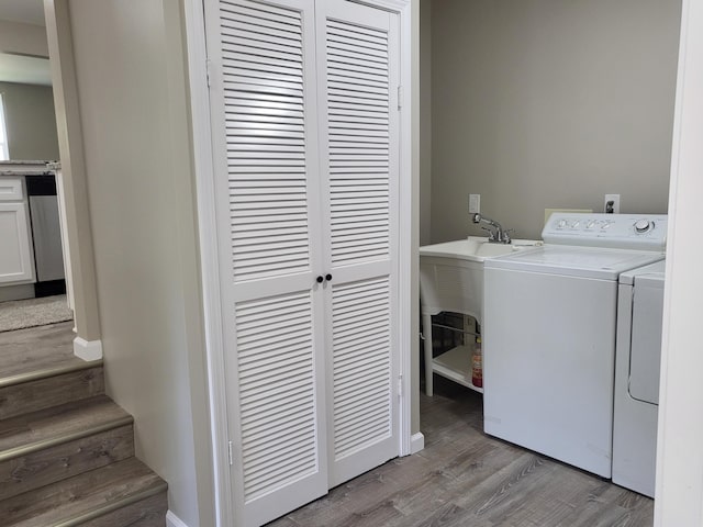 1251 Kingston Ave, Flint, MI 48507 - laundry area with separate washer and dryer and light wood finished floors