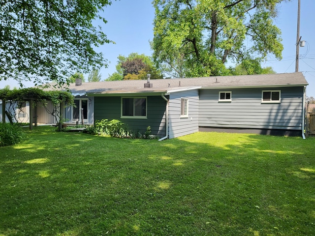 1251 Kingston Ave, Flint, MI 48507 - rear view of property with a lawn and a chimney