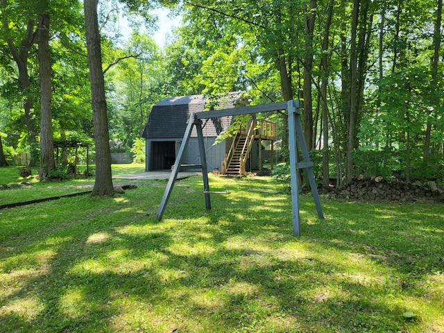 1251 Kingston Ave, Flint, MI 48507 - view of green lawn with an outbuilding, stairway, and a detached garage