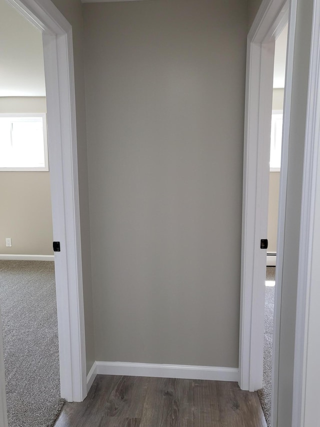 1251 Kingston Ave, Flint, MI 48507 - corridor with a baseboard heating unit and dark wood-style floors