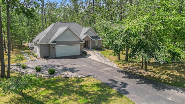 6296 Wolverine Trl, Gaylord, MI 49735 - craftsman house featuring driveway, an attached garage, and roof with shingles